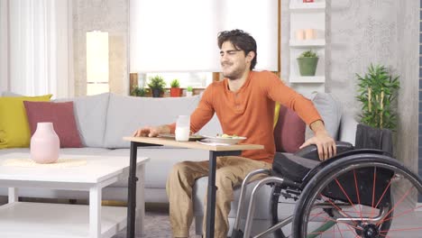 The-physically-disabled-young-man-is-at-home.